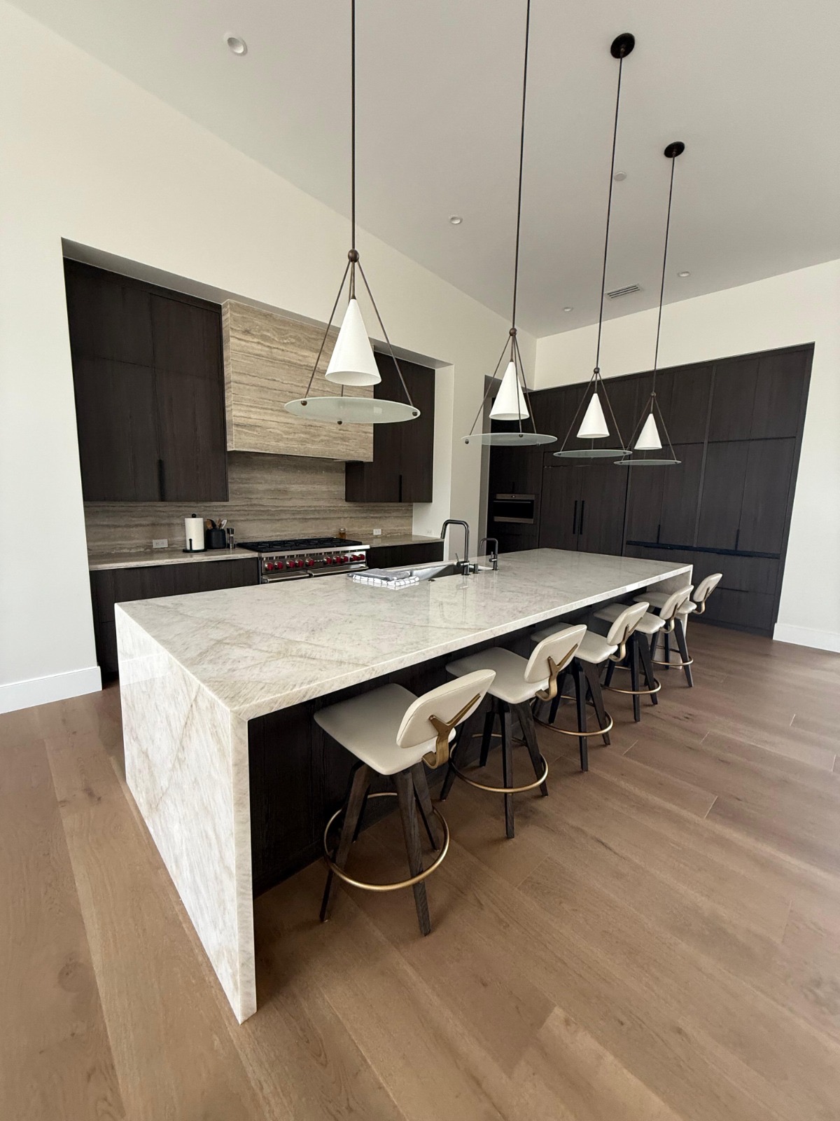 Custom kitchen with marble waterfall island